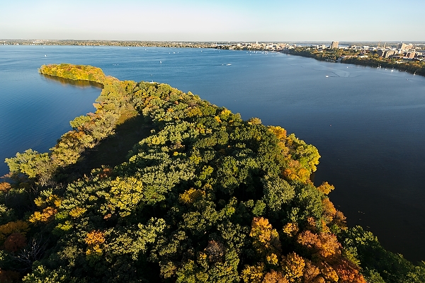 Picnic Point and Lake Mendota are pictured in an aerial view of the University of Wisconsin-Madison campus during an autumn sunset on Oct. 5, 2011. On the horizon is the downtown Madison skyline, right of center, and central UW-Madison campus, at far right. The photograph was made from a helicopter looking southeast. (Photo by Jeff Miller/UW-Madison